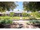 View of a well-maintained single-story home with professional landscaping under a canopy of mature shade trees at 1185 Glencoe St, Denver, CO 80220