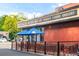 Exterior of a Marczyk Fine Foods wine and cheese shop with tables and umbrellas for outdoor seating at 1185 Glencoe St, Denver, CO 80220