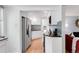 Bright and airy kitchen featuring stainless steel refrigerator and modern backsplash at 1185 Glencoe St, Denver, CO 80220