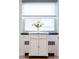Bright kitchen features a mobile island under a large window for food preparation and extra storage at 1185 Glencoe St, Denver, CO 80220