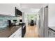 Updated kitchen boasts stainless steel appliances, modern backsplash, and bright breakfast nook at 1185 Glencoe St, Denver, CO 80220