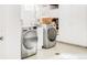 Bright laundry room featuring side-by-side washer and dryer, utility sink, and ample storage space at 1185 Glencoe St, Denver, CO 80220