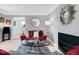 A well-lit living room featuring hardwood floors, a modern fireplace, and stylish furniture with red accents at 1185 Glencoe St, Denver, CO 80220