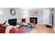 A comfortable living room featuring hardwood floors, a modern fireplace, and stylish furniture with red accents at 1185 Glencoe St, Denver, CO 80220