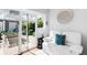 Living room features a white couch and a sliding glass door leading to the backyard at 1185 Glencoe St, Denver, CO 80220