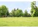 Beautiful community park with lush green grass, mature trees and playground equipment for outdoor activities at 1185 Glencoe St, Denver, CO 80220