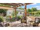 Beautiful stone patio with a dining set, lounge chairs and lush landscaping, creating a relaxing outdoor space at 1185 Glencoe St, Denver, CO 80220