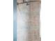 Neutral tiled shower with decorative mosaic stripes and modern shower head at 1185 Glencoe St, Denver, CO 80220