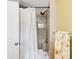 Bathroom featuring tiled shower, shower curtain and chrome shower fixtures at 1185 Glencoe St, Denver, CO 80220