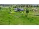 Aerial view of the house with spacious backyard, deck and the surrounding lush green landscape at 10205 Inspiration Dr, Parker, CO 80138