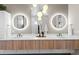 Modern bathroom featuring dual sinks, sleek vanities, and contemporary lighting fixtures at 10205 Inspiration Dr, Parker, CO 80138