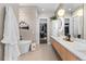 Modern bathroom with double vanity and soaking tub at 10205 Inspiration Dr, Parker, CO 80138