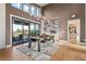 Beautiful dining room with a long wooden table, modern chandelier, and large windows offering scenic views at 10205 Inspiration Dr, Parker, CO 80138