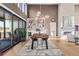 Elegant dining room with modern light fixture, fireplace and sliding glass doors to a deck at 10205 Inspiration Dr, Parker, CO 80138