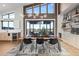 Open dining area with modern lighting, sleek countertops, and views to the backyard at 10205 Inspiration Dr, Parker, CO 80138