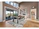 Modern dining room with a stunning chandelier and sliding glass doors leading to a deck at 10205 Inspiration Dr, Parker, CO 80138