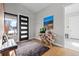 Bright and airy entryway with a modern console table and seating at 10205 Inspiration Dr, Parker, CO 80138