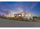 Stunning contemporary home at twilight, showcasing its unique design and inviting illuminated landscape at 10205 Inspiration Dr, Parker, CO 80138