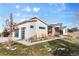 House exterior featuring a three-car garage and attractive landscaping at 10205 Inspiration Dr, Parker, CO 80138