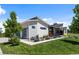 Modern home with a unique roofline, featuring a tandem 3-car garage and manicured landscaping at 10205 Inspiration Dr, Parker, CO 80138