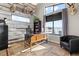 Spacious home office with rustic wood wall and large window at 10205 Inspiration Dr, Parker, CO 80138