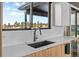Bright kitchen with quartz countertops, stainless steel sink, wooden cabinets and scenic views at 10205 Inspiration Dr, Parker, CO 80138