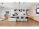 Bright, modern kitchen with stainless steel appliances, spacious island, and contemporary pendant lighting at 10205 Inspiration Dr, Parker, CO 80138