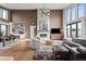Spacious living room featuring high ceilings, a fireplace, hardwood floors, and an open floor plan at 10205 Inspiration Dr, Parker, CO 80138