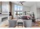 Inviting living room with a fireplace, large windows offering scenic views, plush seating, and stylish decor at 10205 Inspiration Dr, Parker, CO 80138