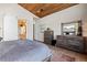 Main bedroom features wood floors, vaulted ceilings, and luxurious ensuite bath with sliding door at 10205 Inspiration Dr, Parker, CO 80138