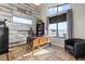 Bright home office with large windows providing natural light and views, vintage desk and accent wall at 10205 Inspiration Dr, Parker, CO 80138