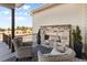 Outdoor deck area with stone fireplace and seating at 10205 Inspiration Dr, Parker, CO 80138