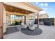 Covered patio features stone accents, outdoor kitchen, and comfortable seating area with mountain views at 10205 Inspiration Dr, Parker, CO 80138