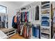 Spacious walk-in closet with custom shelving and ample storage for clothes, shoes and accessories at 10205 Inspiration Dr, Parker, CO 80138