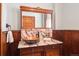 Stylish bathroom features a copper vessel sink, marble countertop, and wood paneling at 1022 N Pearl St # 101, Denver, CO 80203