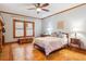 Charming bedroom with an ornate wooden bed, stylish windows and hardwood parquet floors at 1022 N Pearl St # 101, Denver, CO 80203
