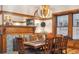 A formal dining room with fireplace and built-in cabinet with a stylish light fixture and wood table at 1022 N Pearl St # 101, Denver, CO 80203