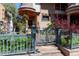 Charming home with a blue iron gate, landscaped garden, and a turret-style covered entryway at 1022 N Pearl St # 101, Denver, CO 80203