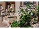 Home's entrance featuring stone lion statues, detailed brickwork, and lush flowering plants at 1022 N Pearl St # 101, Denver, CO 80203