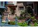 Charming front courtyard with seating area and beautiful landscaping, framed by a decorative fence at 1022 N Pearl St # 101, Denver, CO 80203