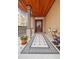 Charming front porch with detailed tile flooring, wood ceiling, and ornate columns at 1022 N Pearl St # 101, Denver, CO 80203