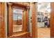Hallway with beautiful wood trim, a large mirror, and a view into the walk in closet with custom organizers at 1022 N Pearl St # 101, Denver, CO 80203