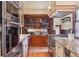A kitchen featuring a gas cooktop, stainless steel appliances, custom cabinets, wood floor and stone countertops at 1022 N Pearl St # 101, Denver, CO 80203