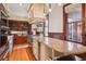 A lovely kitchen showcasing stainless steel appliances, custom wood cabinets, stone countertops and a large cooktop at 1022 N Pearl St # 101, Denver, CO 80203