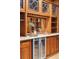 Wet bar area with custom wood cabinets and shelving, featuring a sink and beverage cooler at 1022 N Pearl St # 101, Denver, CO 80203