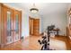 Workout room featuring wood trim, a decorative light fixture, and hard wood floors at 1022 N Pearl St # 101, Denver, CO 80203