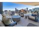 Cozy outdoor seating area on balcony with comfortable furniture and incredible city skyline view at 1133 14Th St # 3320, Denver, CO 80202