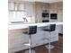 The kitchen features stainless steel appliances, sleek countertops, hardwood floors, and a bar with seating at 1133 14Th St # 3320, Denver, CO 80202