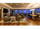 Living room featuring a fireplace, city views, and an open floor plan with hardwood floors at night at 1133 14Th St # 3320, Denver, CO 80202