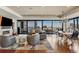 Modern living room featuring a fireplace, city views, and an open floor plan with hardwood floors at 1133 14Th St # 3320, Denver, CO 80202